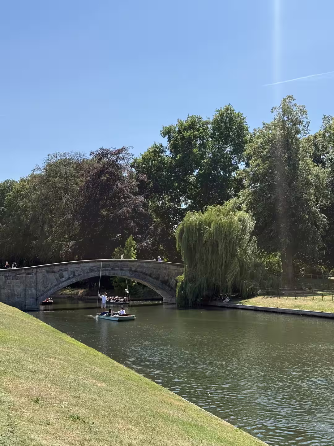 A historic stone bridge over the River Cam on the Cambridge College Backs